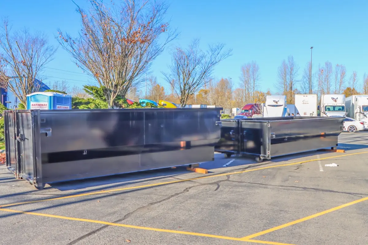 Professional dumpster rental service with roll-off container on residential driveway in East Chicago